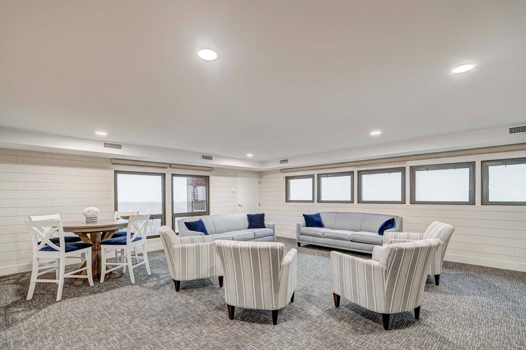 a living room with couches and chairs and a table