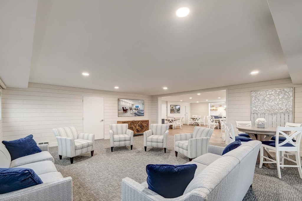 a living room with couches and chairs and a dining room