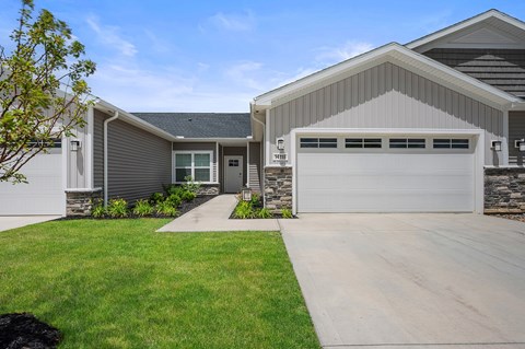 A modern house with a grey garage door.