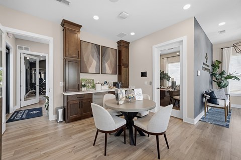 A dining room with a table and chairs.