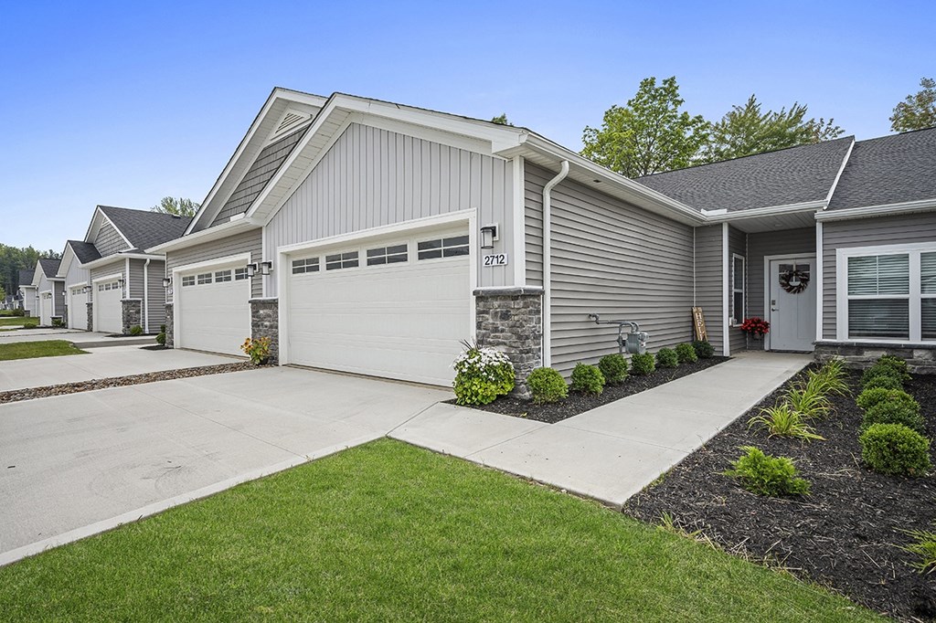 a white house with a driveway and a garage door