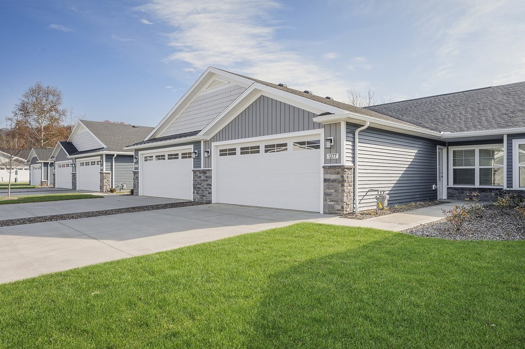 the front of a house with a driveway and a garage door