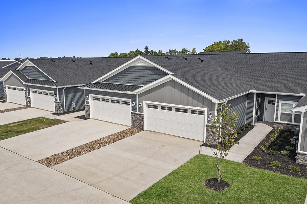 a house with a driveway and garage doors
