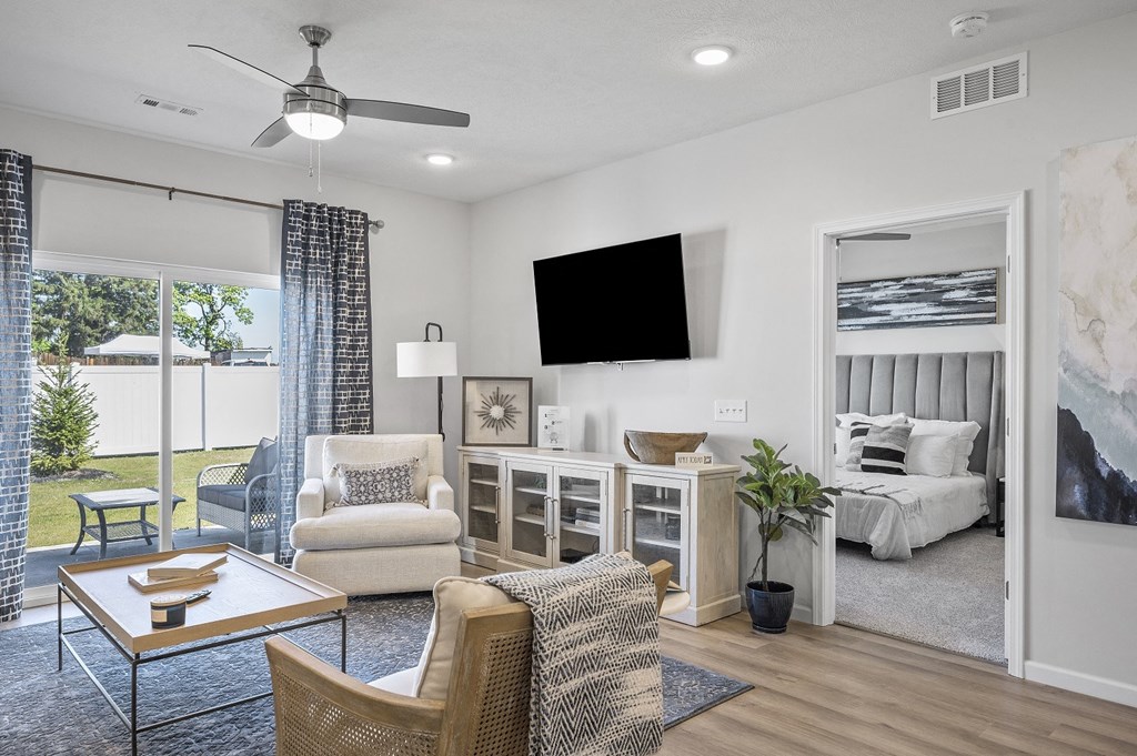a living room with a couch and chairs and a tv