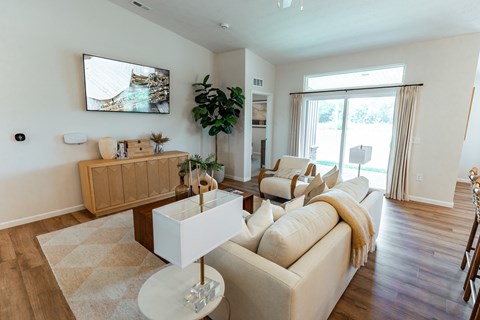 A living room with a white couch and a wooden coffee table.