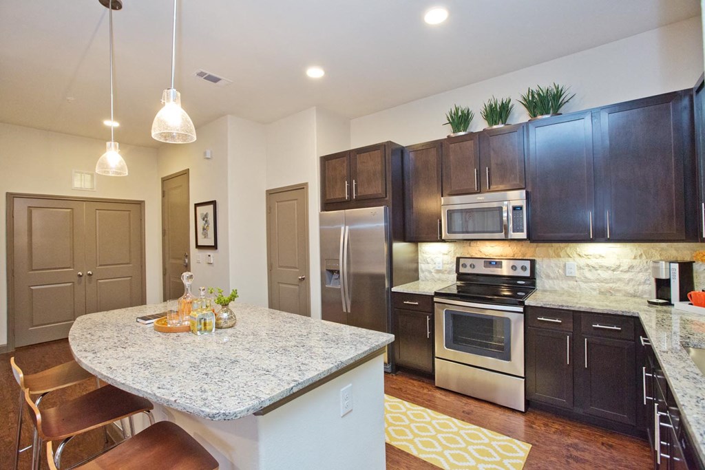 a kitchen with stainless steel appliances and granite counter tops