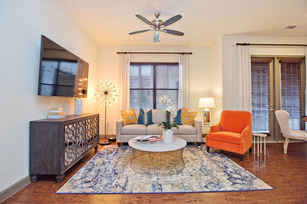 a living room with furniture and a ceiling fan