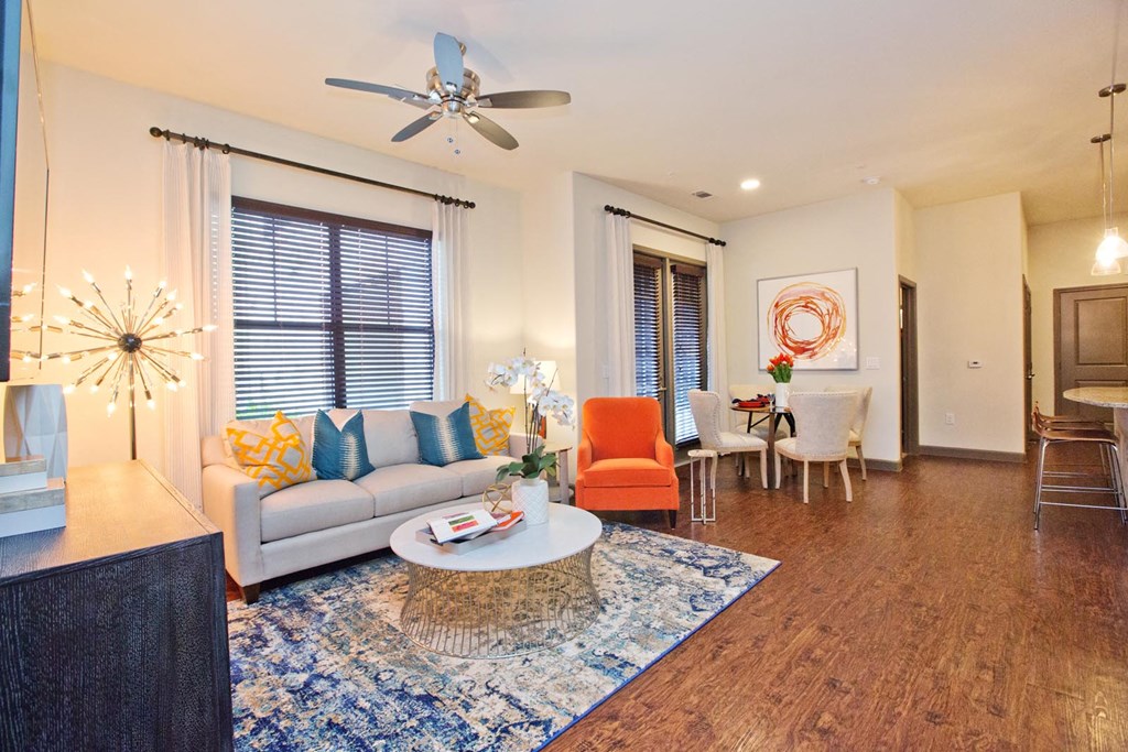 a living room with a couch and a ceiling fan