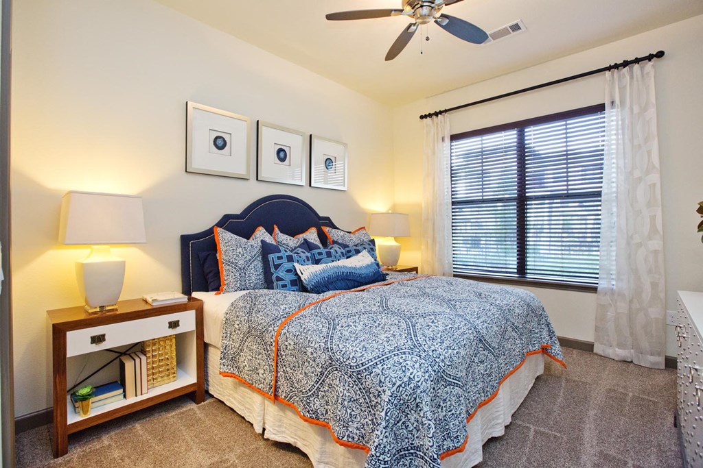 a bedroom with a bed and a ceiling fan