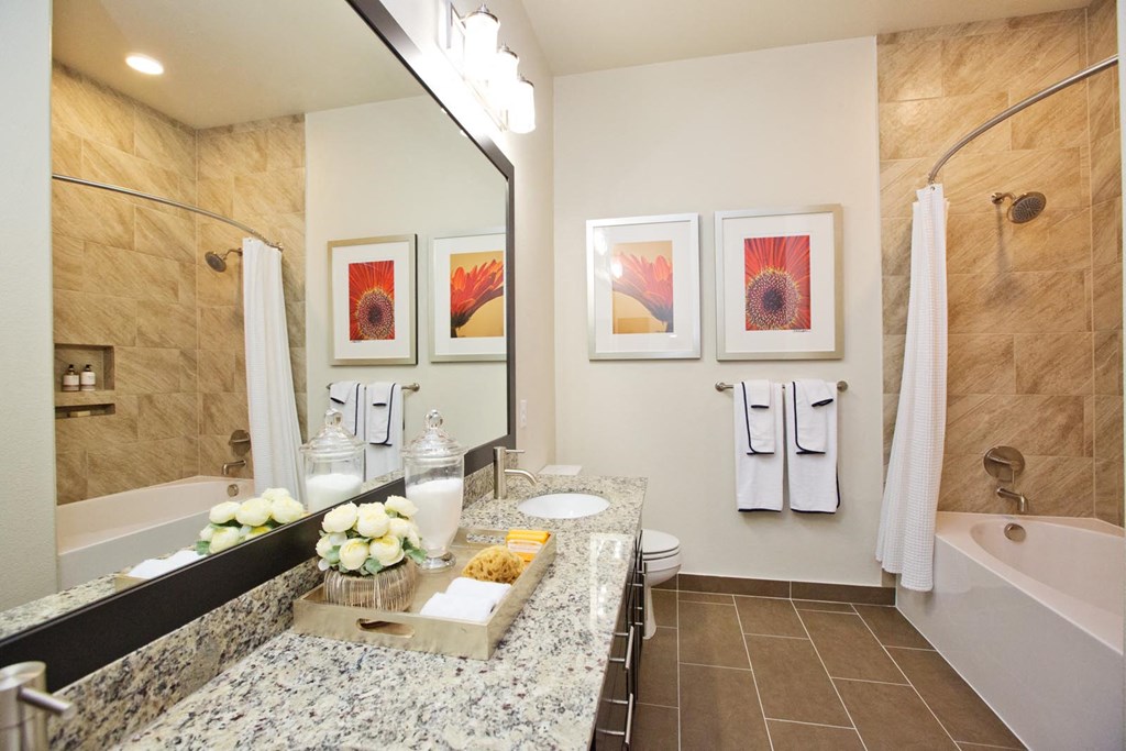 a bathroom with a sink and a tub and a mirror