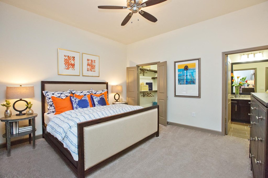 a bedroom with a bed and a ceiling fan