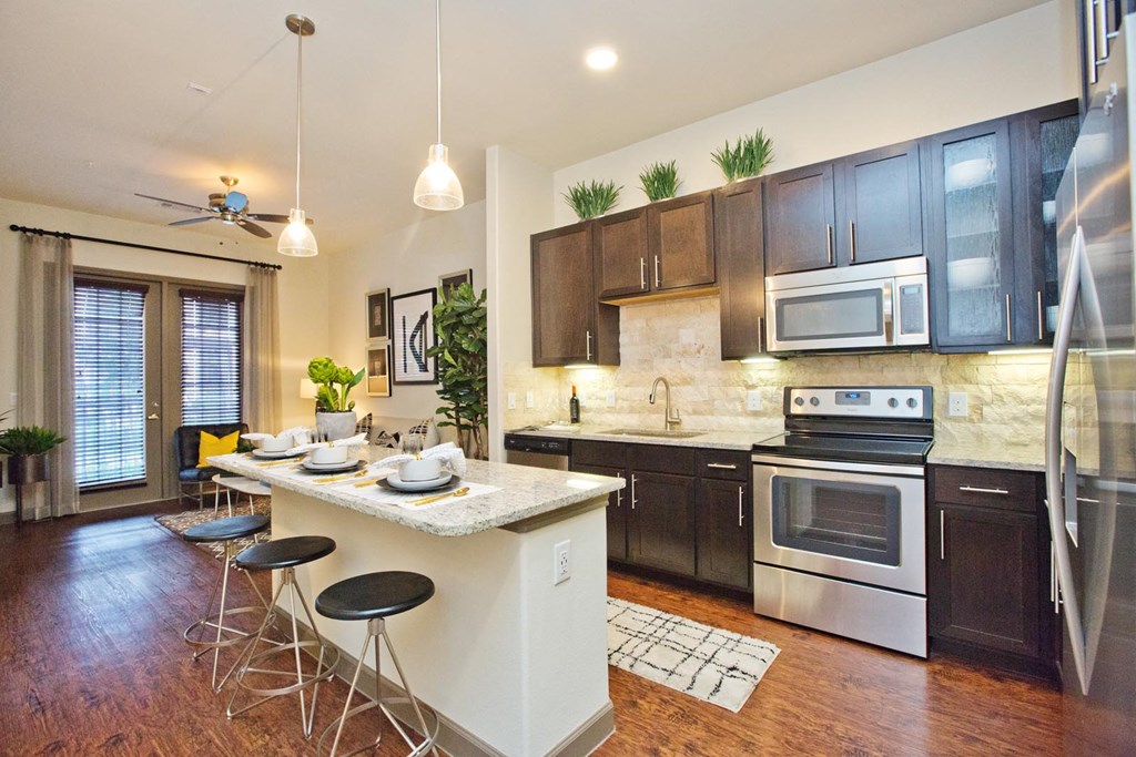 a kitchen with an island and a table with chairs