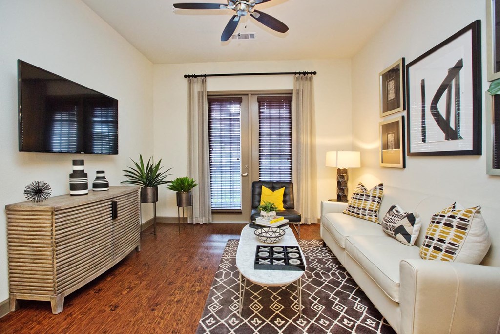 a living room with a white couch and a tv