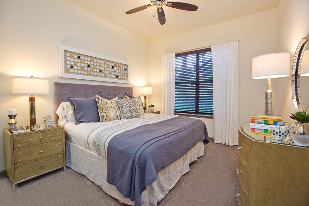 a bedroom with a bed and a ceiling fan