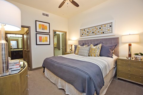 a bedroom with a bed and a ceiling fan