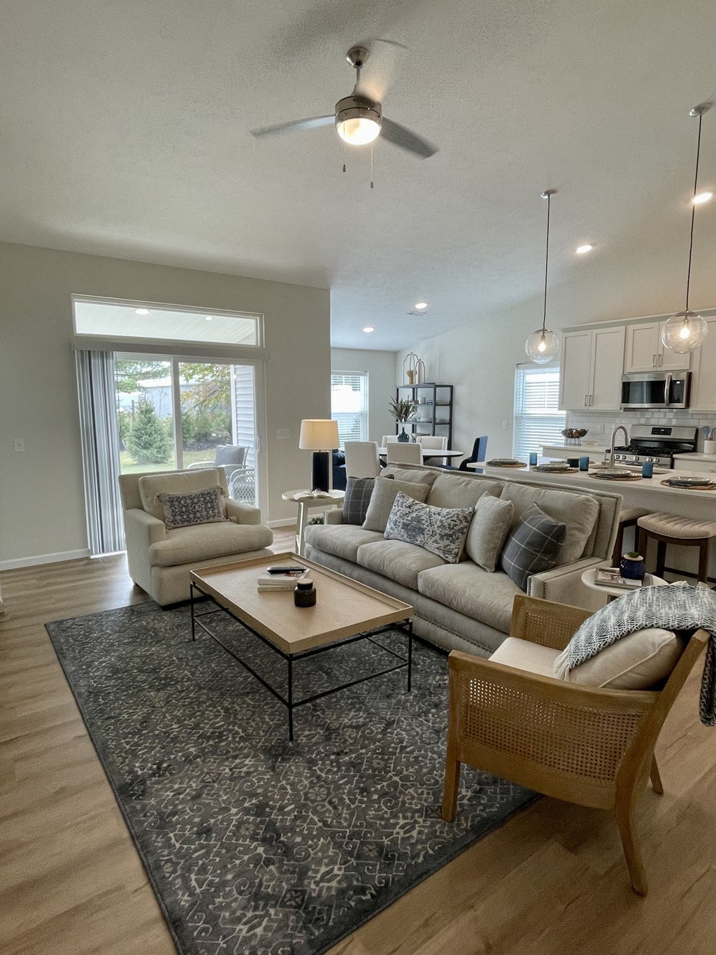 a living room and kitchen with couches and a table