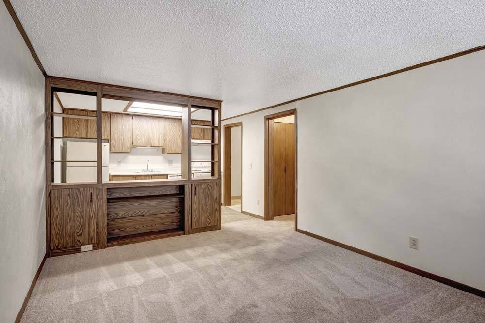 A kitchen area with a sink and cabinets.