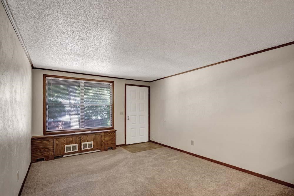 A room with a window and a door.