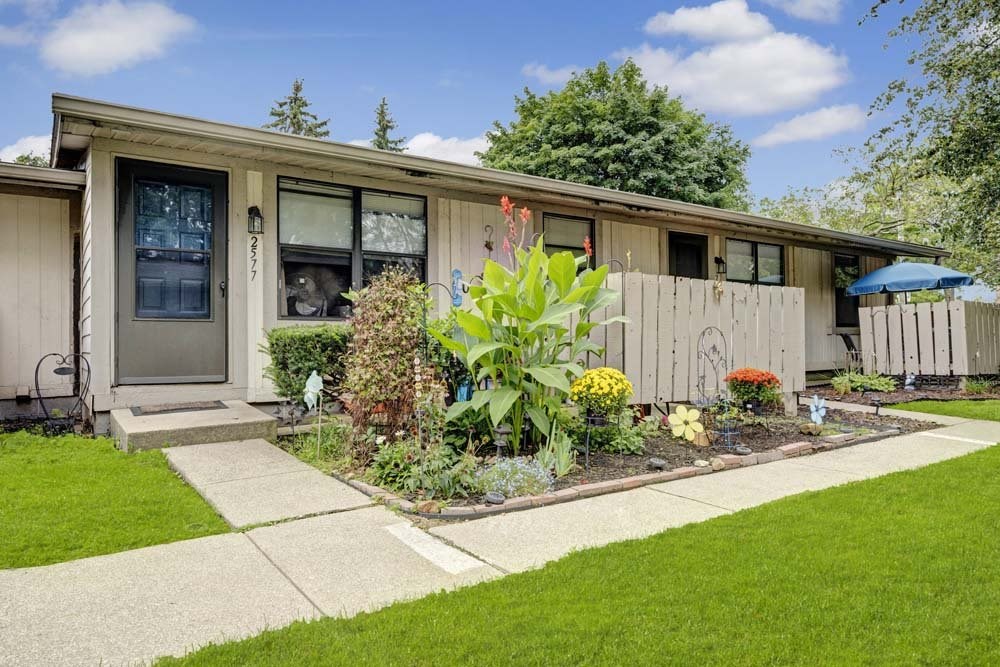 A house with a well-maintained garden in front.