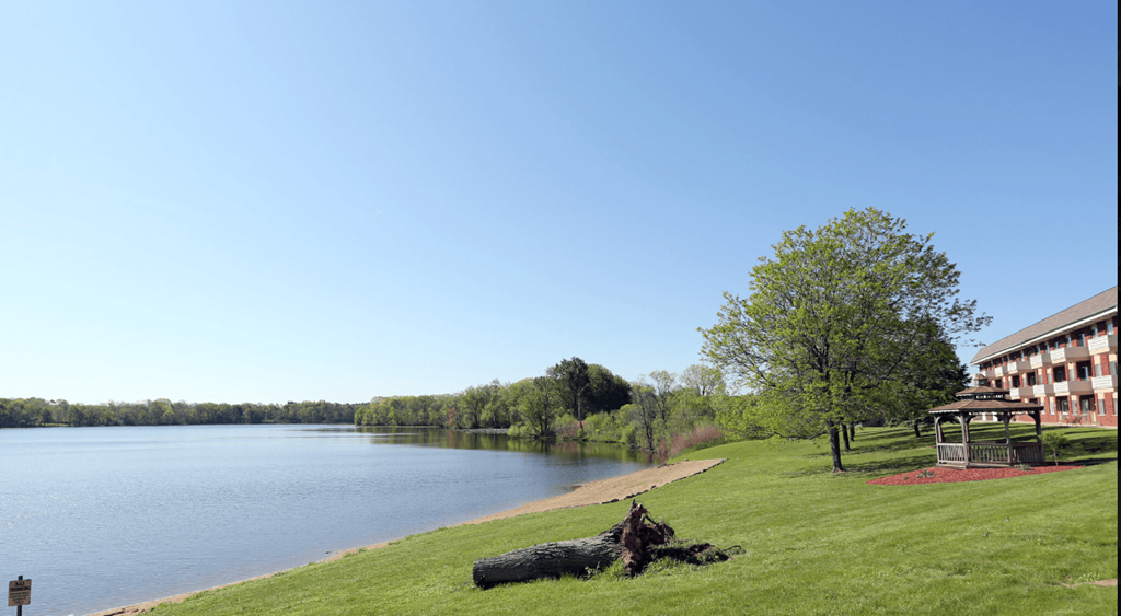 A large body of water with a building in the background.