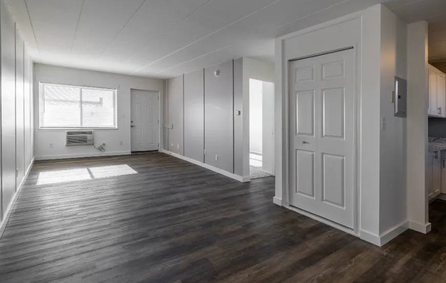 A room with wooden floors and white walls.