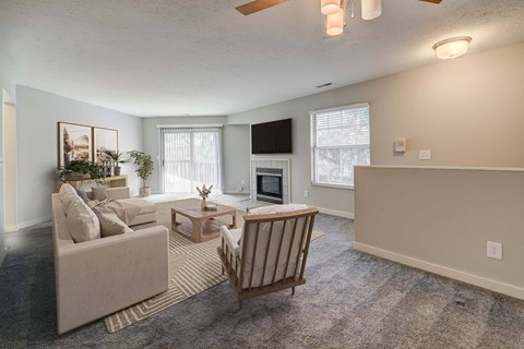 A living room with a couch, chair, and television.