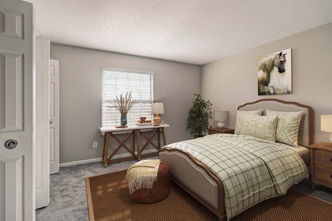A bedroom with a bed, a bench, and a potted plant.