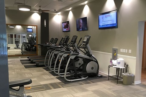 A gym with treadmills and exercise bikes.