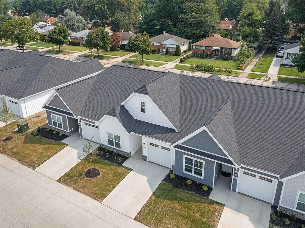 a neighborhood of houses with gray roofs and white walls