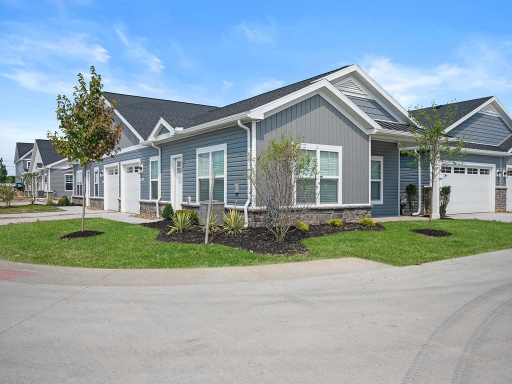 a blue house with a street in front of it