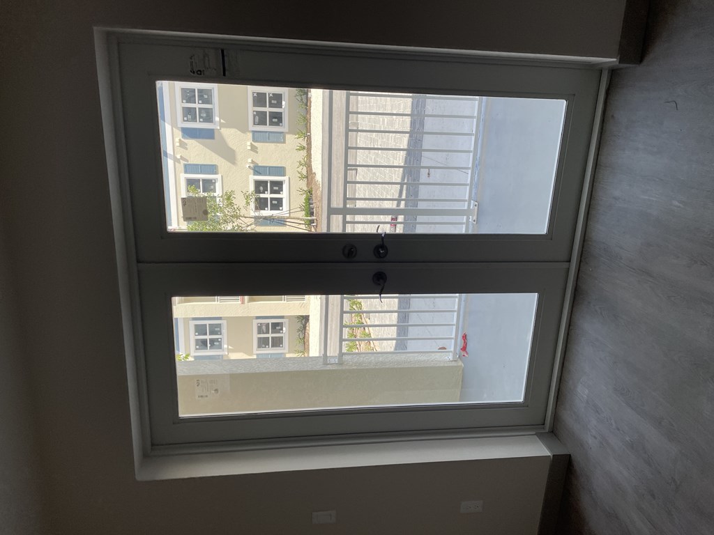 A window with a view of a building across the street.