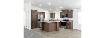 A kitchen with brown cabinets and stainless steel appliances.