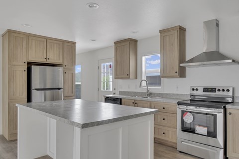A kitchen with a stainless steel refrigerator and oven, and wooden cabinets.