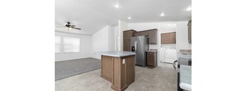 A kitchen with a refrigerator, stove, and oven.