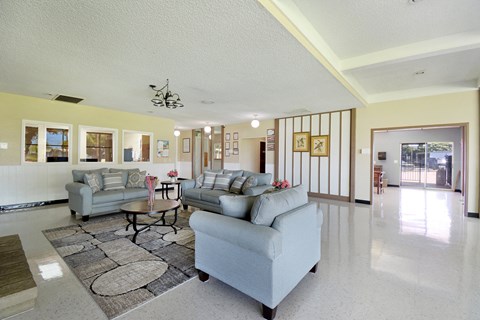 A living room with a grey couch and a coffee table.