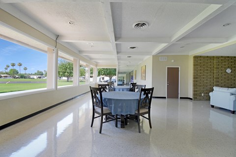 A dining room with a table set for four.