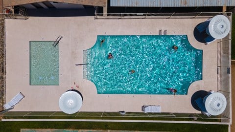 an aerial view of a swimming pool on the side of a building