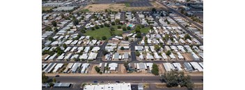 A large, open field is surrounded by a grid of houses.