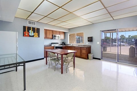 a kitchen and dining room with a table and chairs