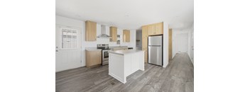a kitchen with white cabinets and stainless steel appliances