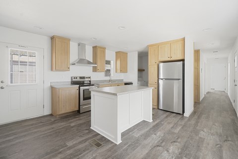 Rental Home Kitchen with stainless steel appliances, wood floors, and large kitchen island.