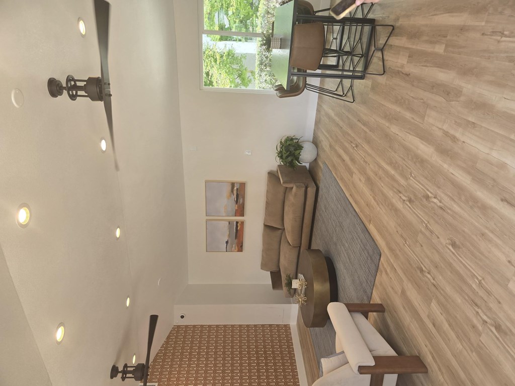 A bathroom with a wooden wall and a window.