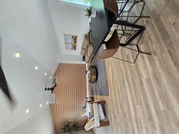 A living room with a couch and a television.