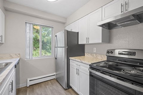 a kitchen with a stove and a refrigerator