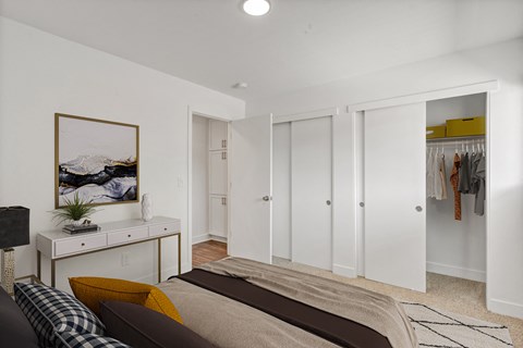 a bedroom with white walls and white closets