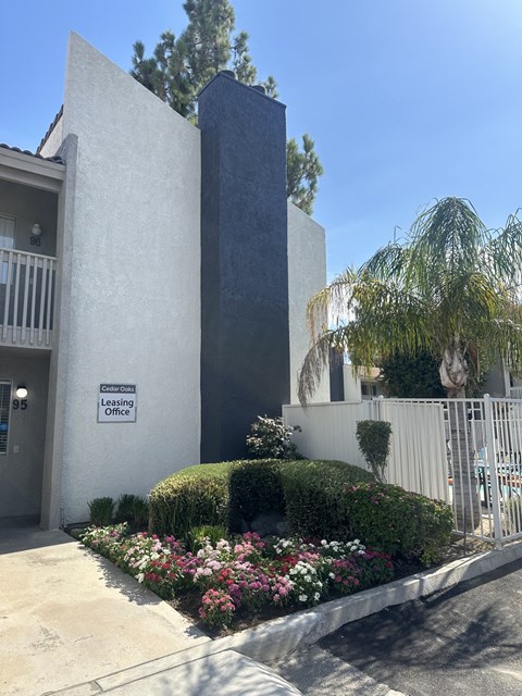 a building with a flower garden in front of it
