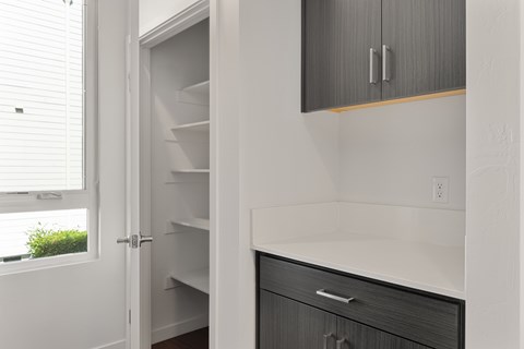 A kitchen with a white door and a black drawer.