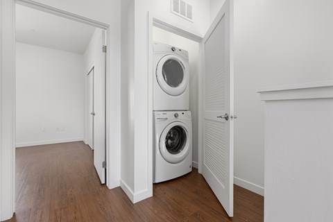 A white laundry room with a washer and dryer.