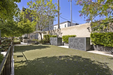 A park with a bicycle symbol on a wall.