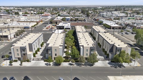 A view of a city with apartment buildings and cars.